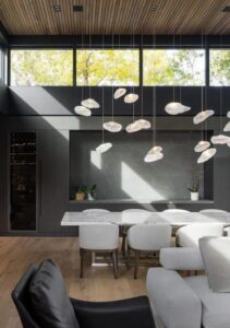 Contemporary grey kitchen featuring sleek, minimalist design with stainless steel appliances, quartz countertops, and ample natural light. The monochromatic color palette creates a sophisticated and stylish space, while the clean lines and strategic lighting enhance the modern aesthetic.
